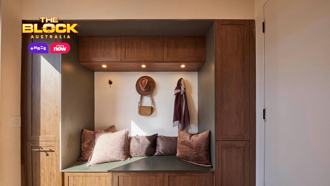 Mudroom nook from The Block with timber cabinetry, built-in bench, cushions, and wall hooks.