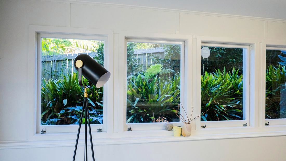 Lamp in a room with windows in it