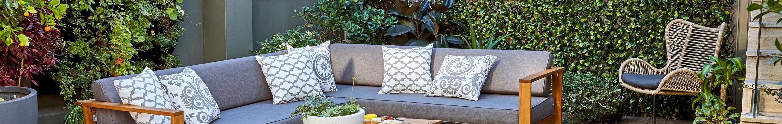 Small backyard with L-shaped outdoor couch and table setting