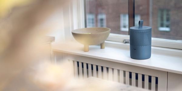 Stylish blue moisture absorber sitting on a window sill