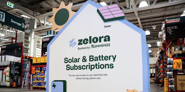 Zelora Solar and Battery Subscriptions display inside a Bunnings store, featuring solar and battery graphics.