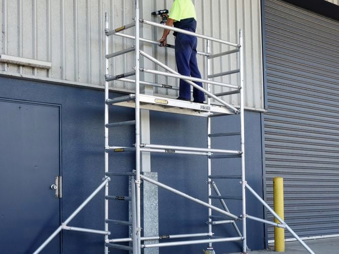 tradesperson working on a ladder