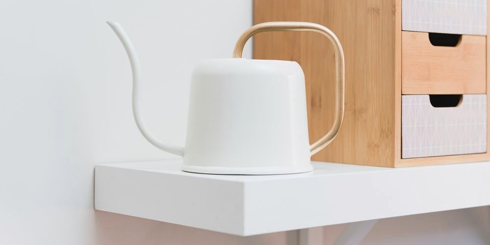 white and gold watering can