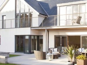 Two storey house with lots of windows and high ceilings