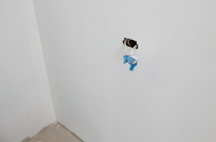 Taped off power cables protruding from a hole in a wall