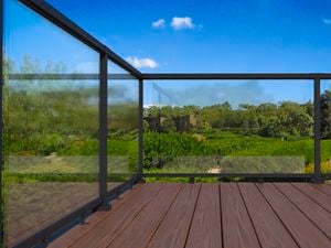 Black balustrade on wooden decking outside.