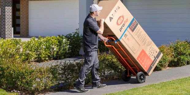 man carrying  an electric water heater