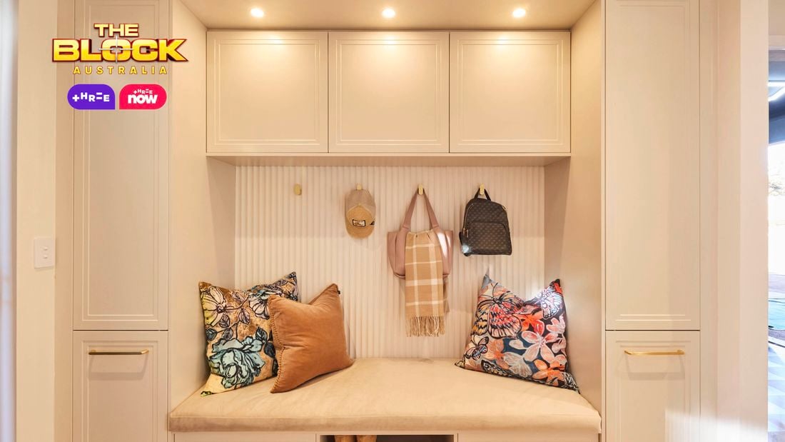 Mudroom nook from The Block with built-in bench, overhead cupboards, cushions, hooks, and shoe storage.