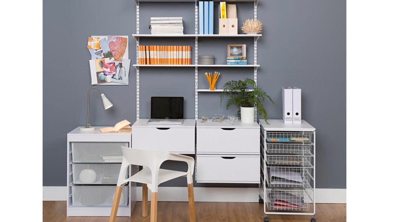 A wall-mounted shelf system featuring a desk, chair and wire storage drawers.