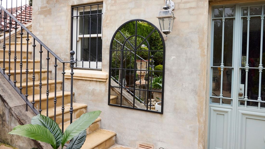 Mirror set up on painted outdoor wall 