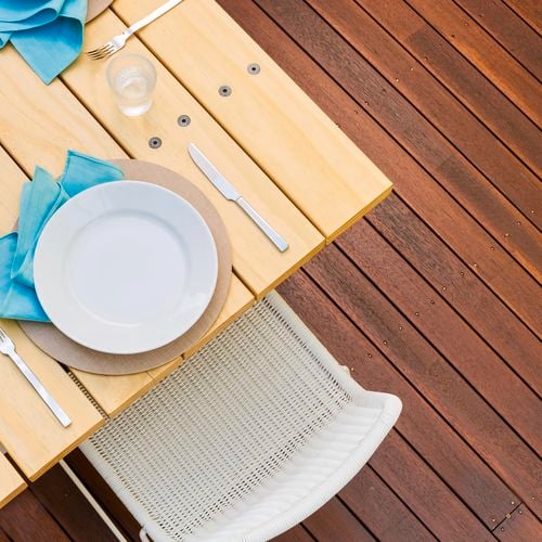 Outdoor table and deck with Cabot's Exterior Clear and Cabot's Aquadeck