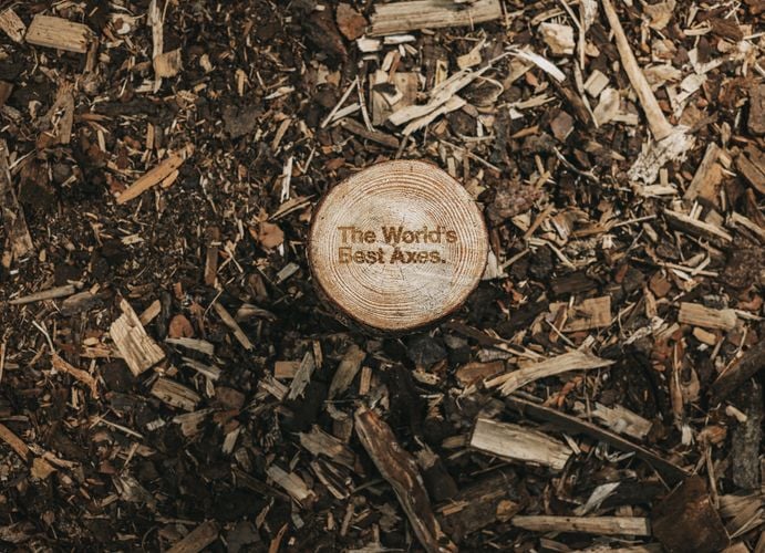Topdown image of an upright log branded with the words "The world's best axes"