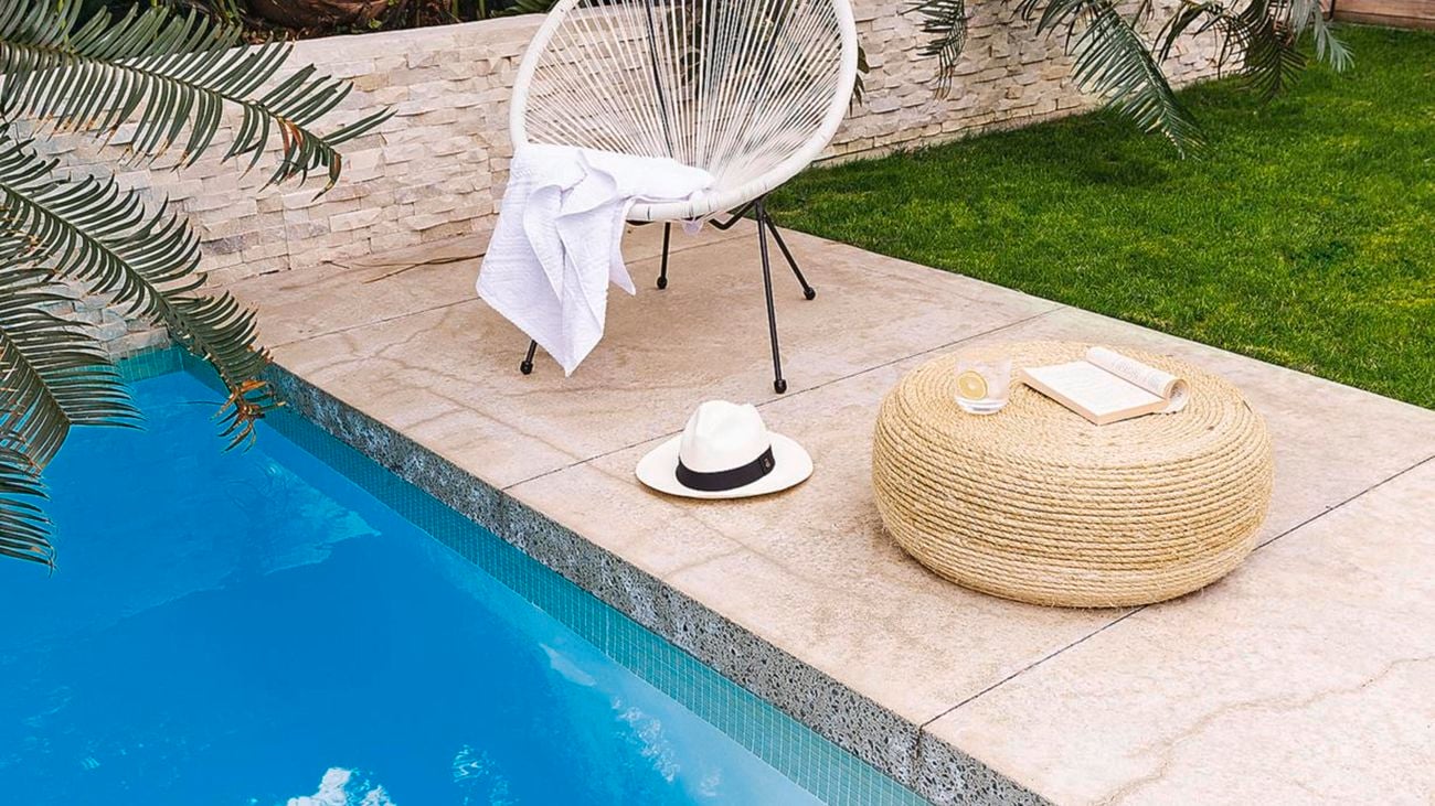 Chair and towel next to pool.
