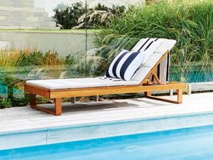 Sun lounge next to pool.