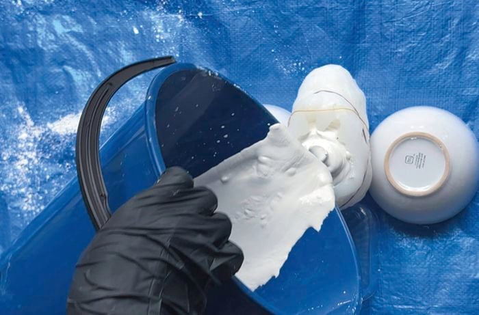 Person pouring mix into your mould. Give the mould a gentle tap to help settle the plaster and remove any air bubbles