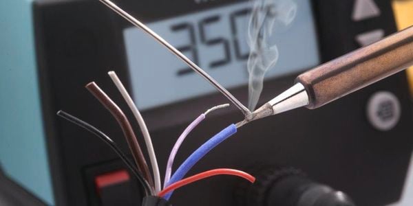 Close up of solder being applied to an electrical wire