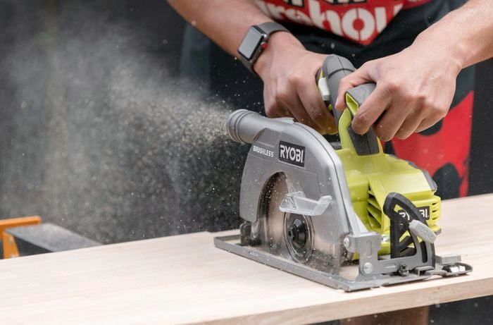 Circular saw cutting through timber board