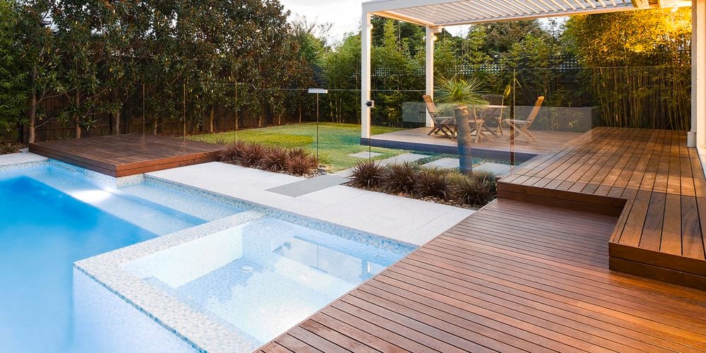 Pool with decking, timber decorative screening and concrete edging