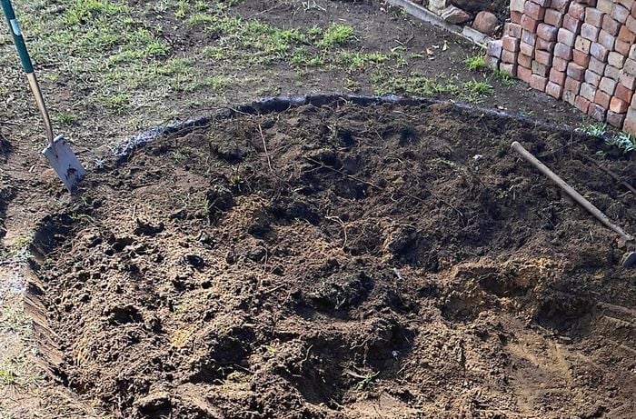 A circle patio base is marked and dug out