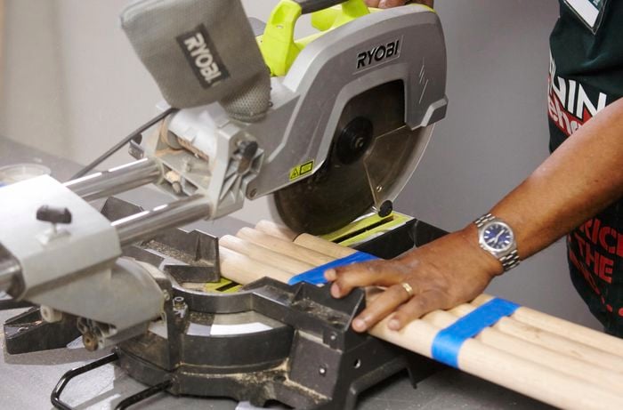 Bar stool legs being cut with a mitre saw