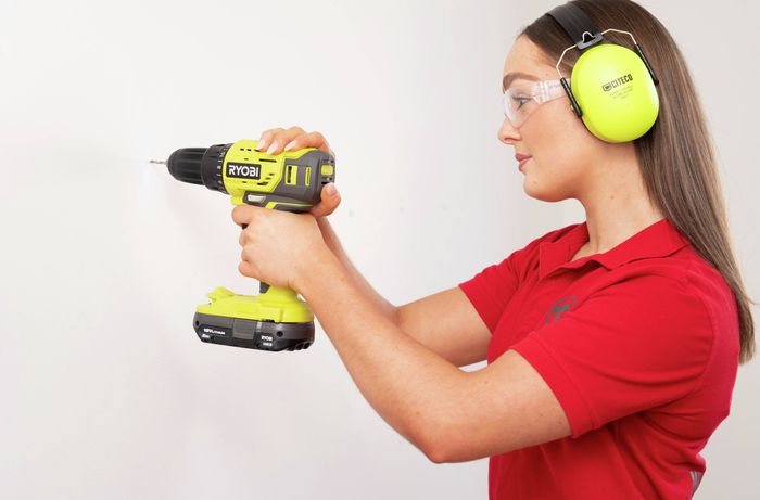 Person using a drill after identifying a stud location with a stud finder.