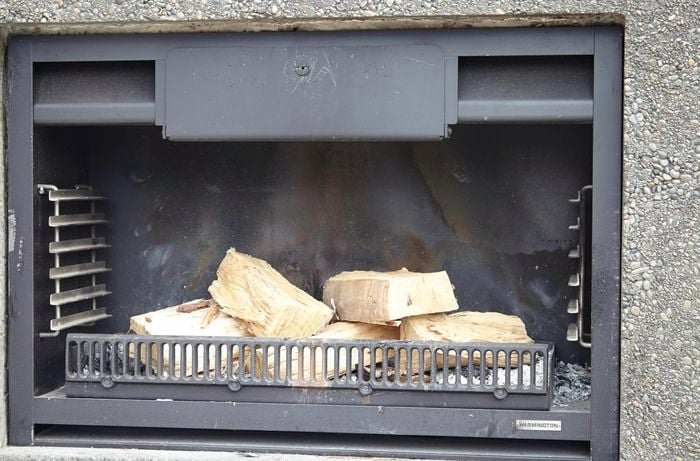 Fireplace with freshly cut wood sitting in it