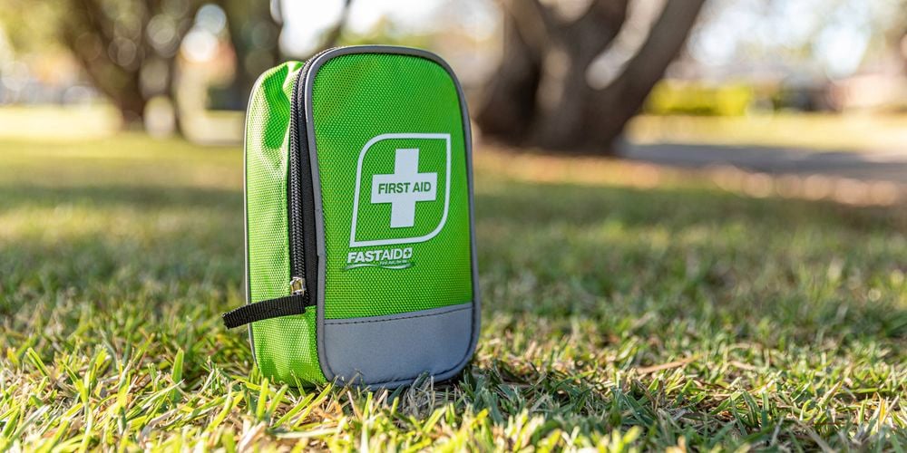 FastAid Green Compact Soft Pack First Aid Kit on the grass