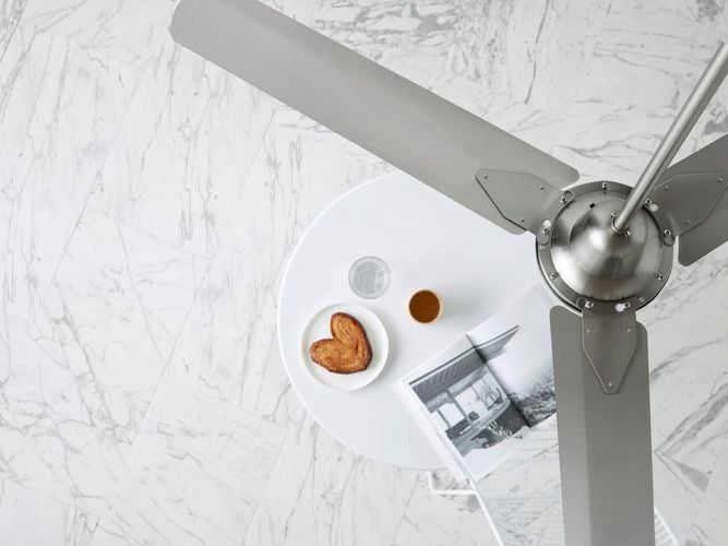 Fan overlooking table with food, drink and book 