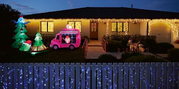 House decorated with Christmas lights and Christmas inflatables