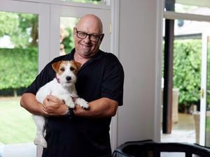 A person holing his puppy.