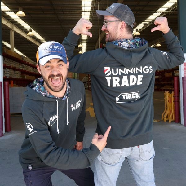 Two people at the front of Bunnings wearing Bunnings TIACS merchandise