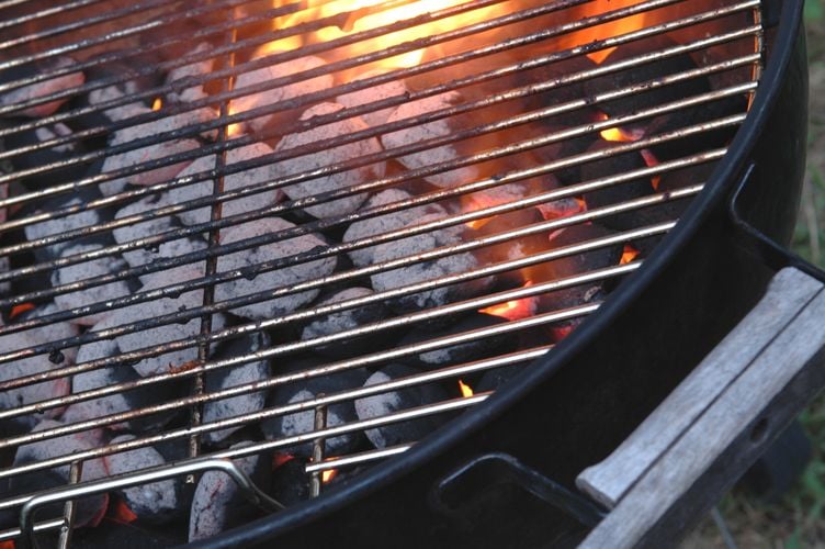 Lit heat beads under a grill