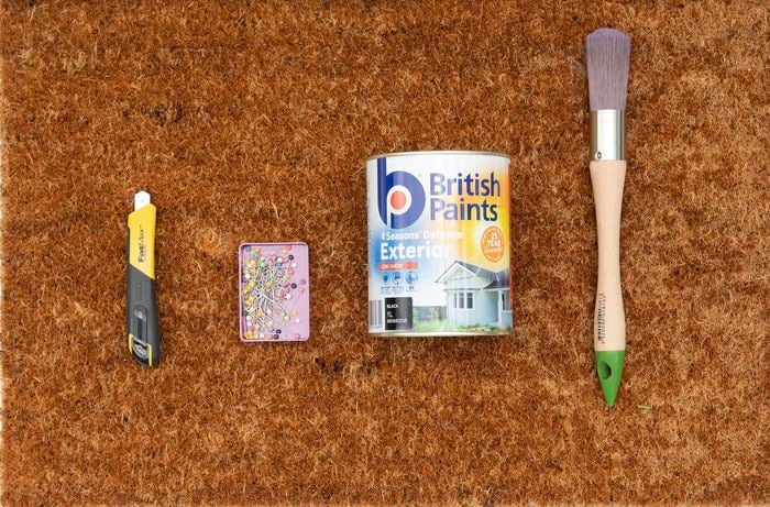Assorted tools, paint brush, door mat and paint