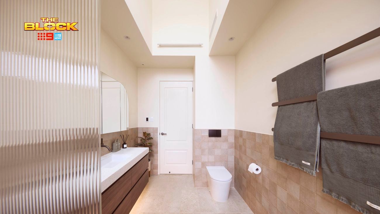 Natural coloured brown bathroom with timber vanity with towel rails and toilet