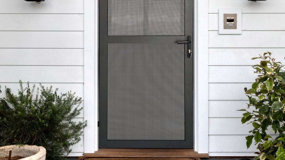 Close up of a house with a black security door