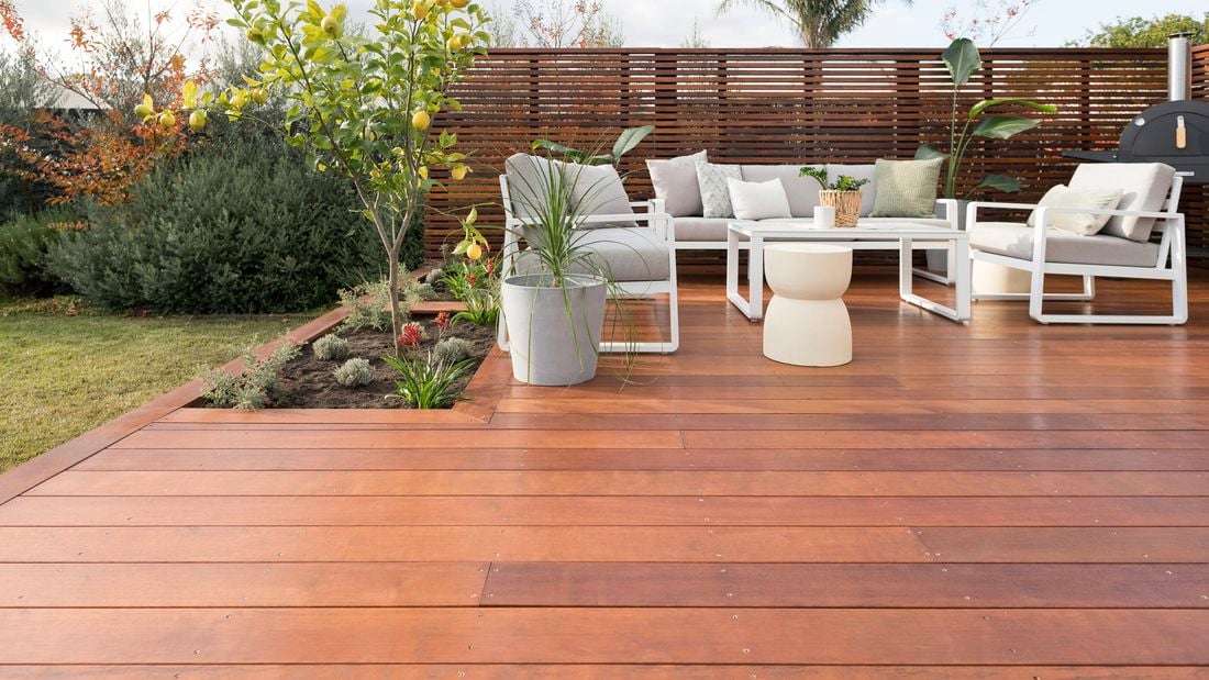 Outdoor furniture setting on a deck in the backyard of a house