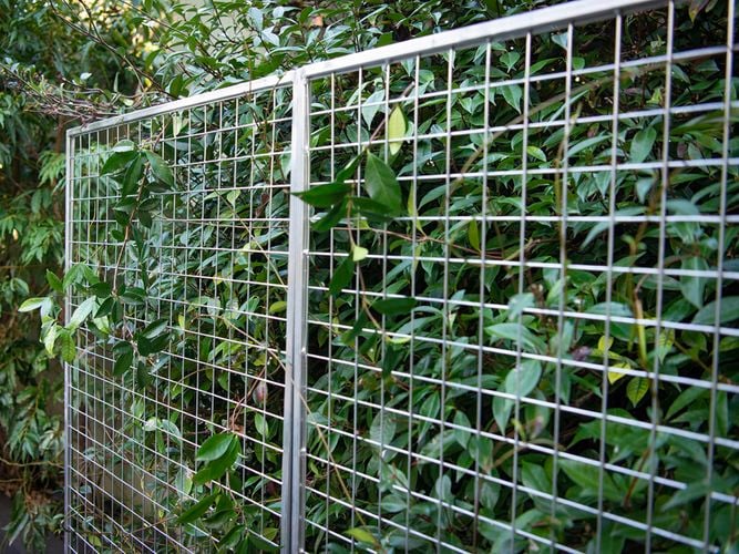 Mesh panelling standing against a bush