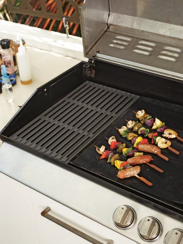 Skewered meats and vegetables cooking on a barbecue