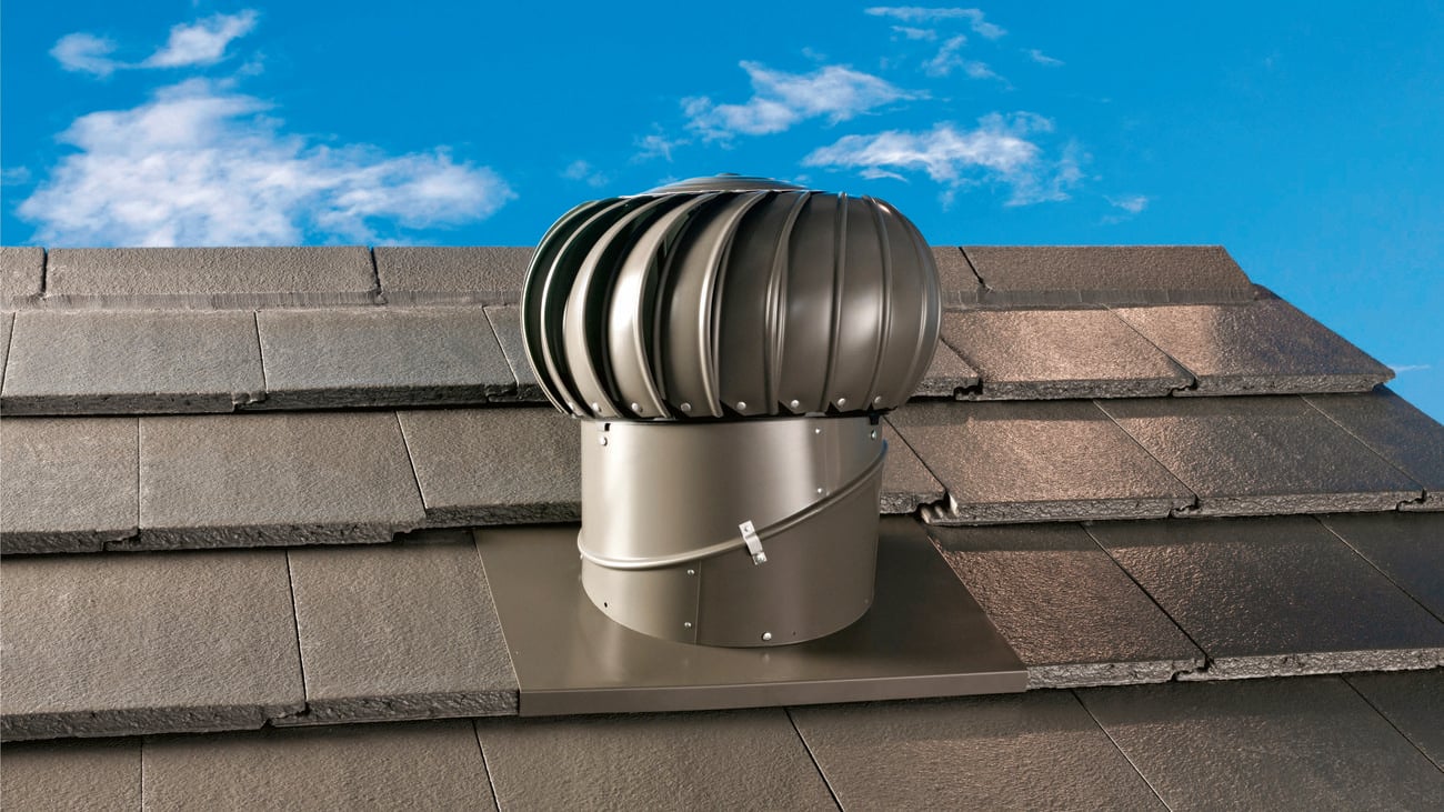 Close-up image of a silver ventilator attached to a roof