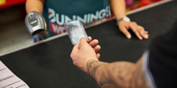 Customer holding PowerPass card at register