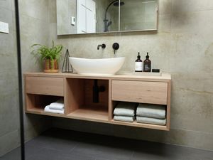 Floating vanity unit in a marble look tiled bathroom