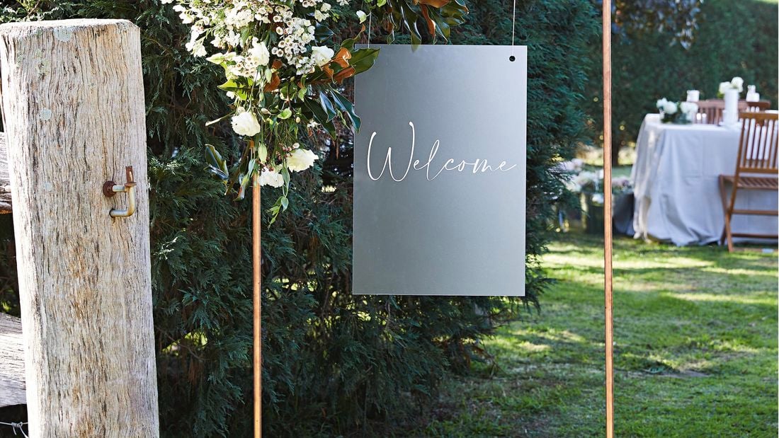 A creative D.I.Y. copper frame, hung with a lightweight sign that reads 'Welcome'.