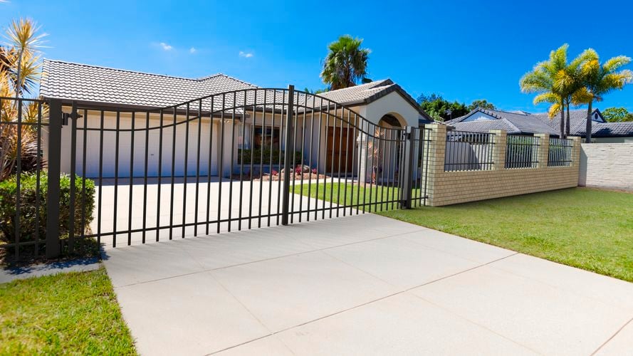 Steel gate and fence installed in front of cream house