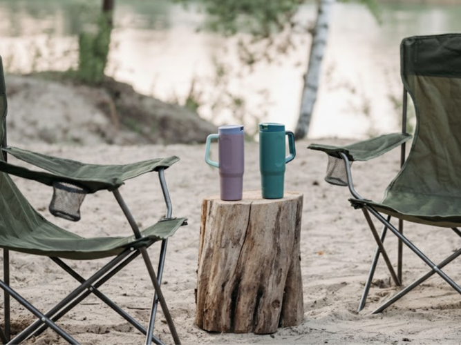 there is two cup holders resting on a timber log, 