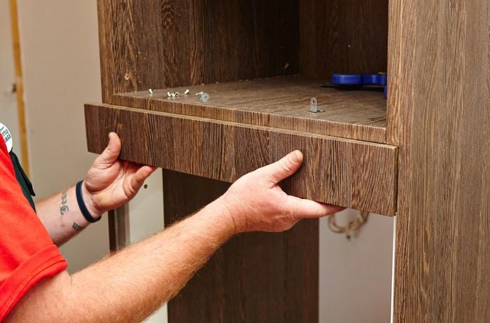 A face panel being attached to an oven tower