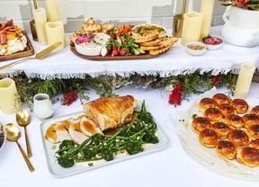 Pull-apart garlic, cheese and smoky capsicum rolls in a buffet setting.