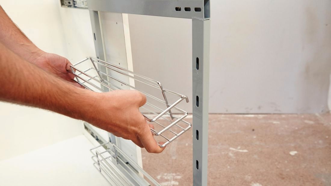 A basket being added to a shelving frame
