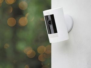 Ring security camera hung on a rendered wall 