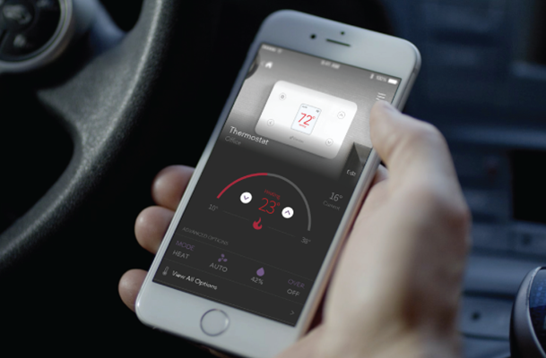 Person viewing app connected to home thermostat