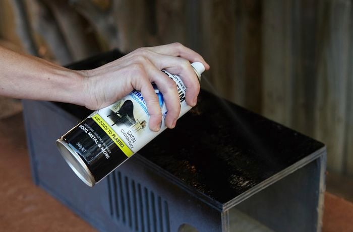 A completed box being spray painted black